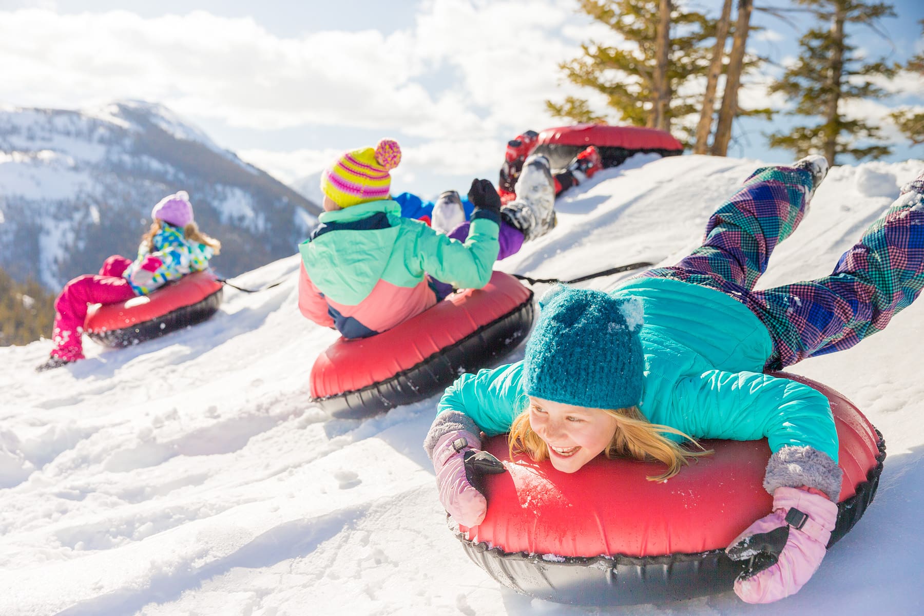 Kids tubing down a hill