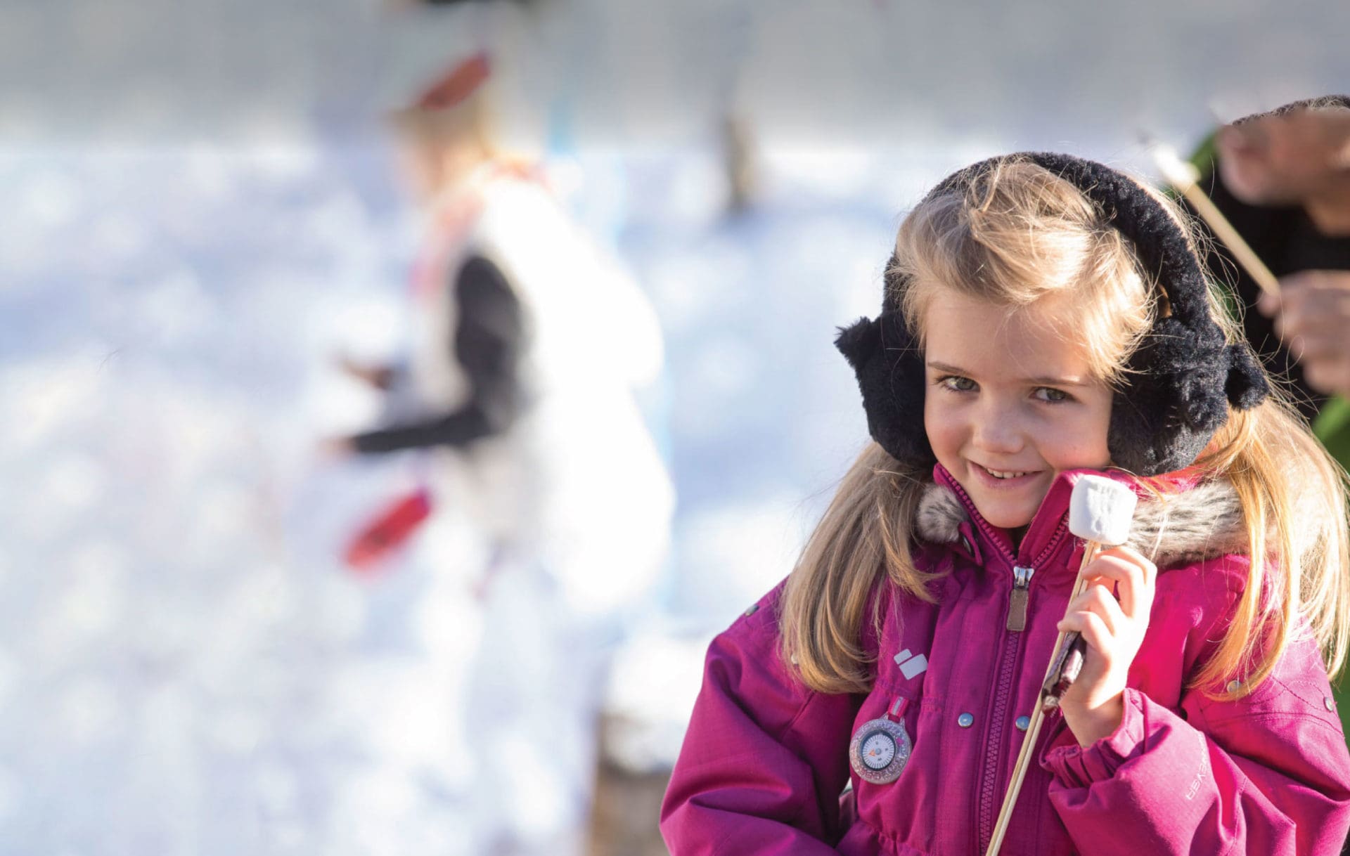 Little girl outside with earmuffs on during winter